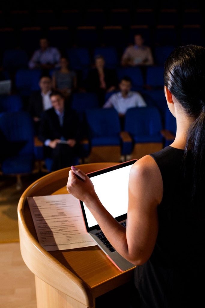 Speaker presenting from podium to audience at NexGen Banking Summit US Edition