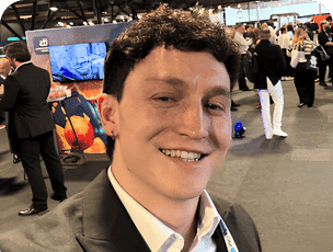 Dominic Walsh smiling at a busy conference