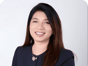 Tania Amid Muhammad professional headshot smiling and wearing a dark blue top